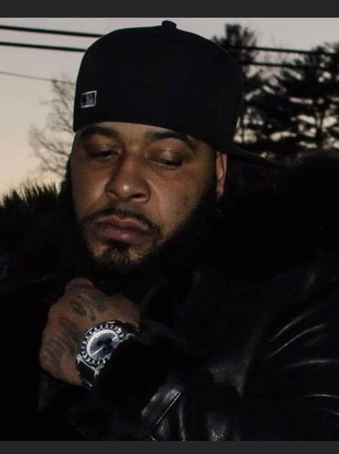 Caleb Love in a black cap and winter coat at dusk